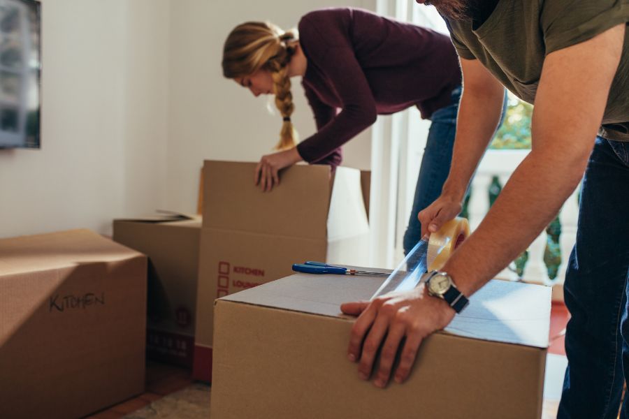 family members packing the belongings of the deceased in boxes