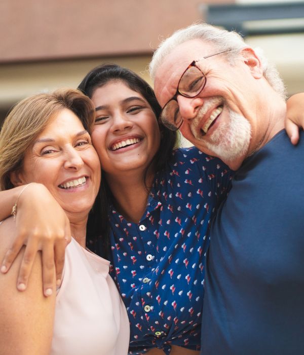 A family with their adult daughter hugging after completing their estate plan A family with their adult daughter hugging after completing their estate plan